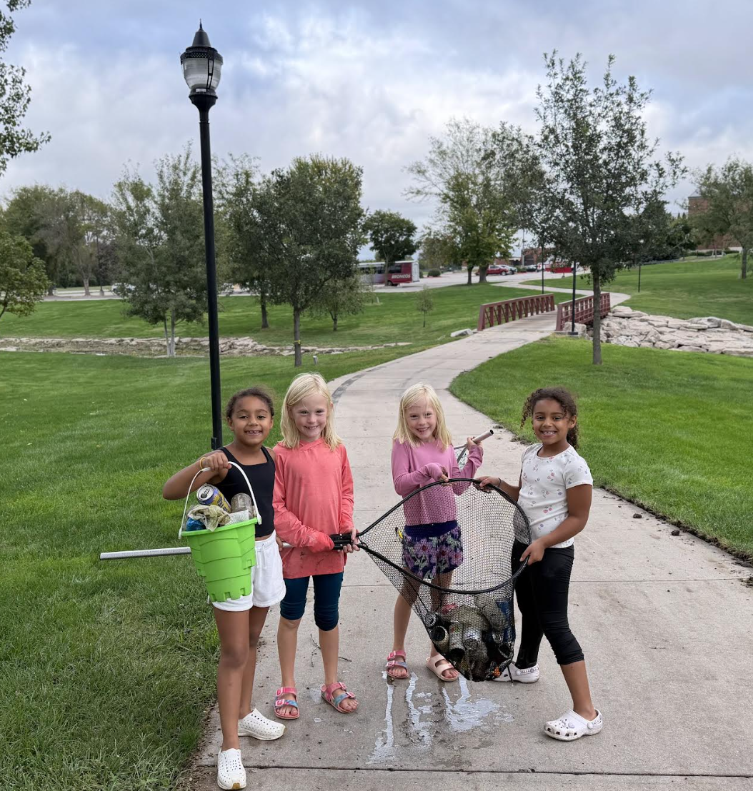 Four 2nd grade girls clean up the park.