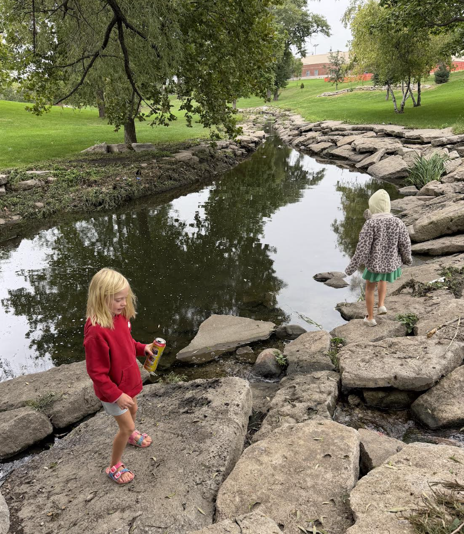 2nd grade girls cleaning up the park together.